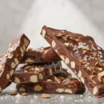 Date Bark Recipe – Easy, Healthy, and Delicious No-Bake Treat 2 Homemade date bark recipe with chocolate and almonds on parchment