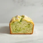 Lemon Zucchini Bread – Moist, Citrusy, and Perfect for Summer Baking 4 Sliced lemon zucchini bread on white background