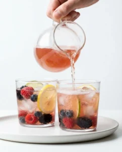 Berry citrus kombucha spritzer being poured to enjoy benefits of kombucha for females gently