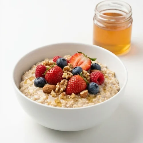Canaan Honey For Memory: Safe Recipes And Real Brain Benefits 3 Oat bowl with berries, nuts, and canaan honey drizzle on a white background.