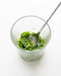 Mint and lime being muddled for cooler that supports how often to drink kombucha wisely