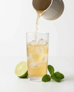Mint lime kombucha cooler being poured, showing how often to drink kombucha in a light way