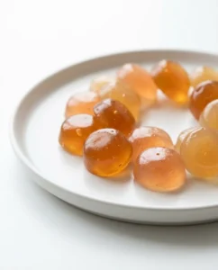 Glossy kombucha gummies on a white plate showing the finished kombucha gummies recipe
