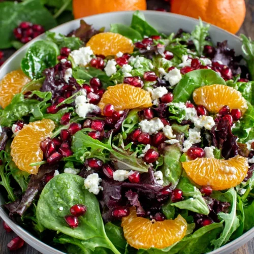 Vibrant Christmas Salad with orange segments and pomegranate seeds.