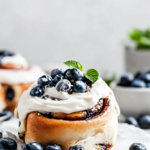 Cinnamon Rolls: Irresistibly Soft and Fluffy 1 Delicious cinnamon rolls with blueberries and cream cheese frosting.