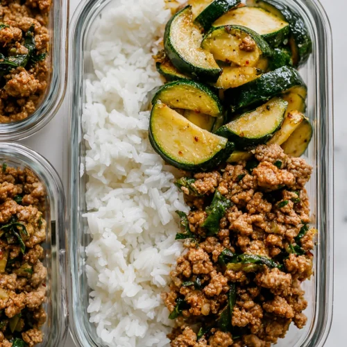 ground turkey meal prep with zucchini and rice in glass meal-prep container