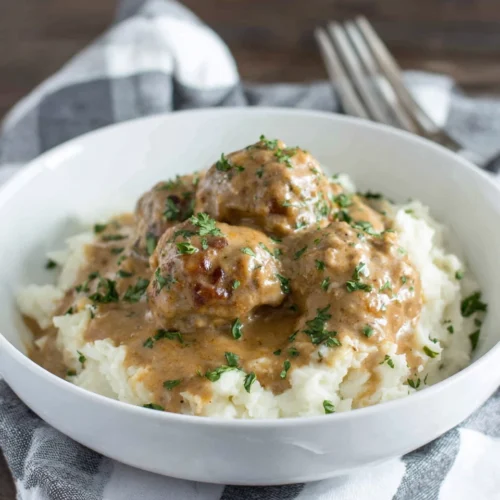 Delicious ground turkey meatballs with gravy over mashed potatoes.