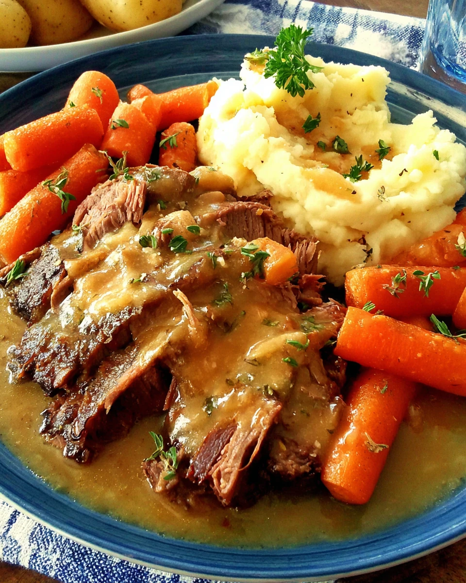 Delicious Lipton onion soup pot roast with carrots and gravy on a plate