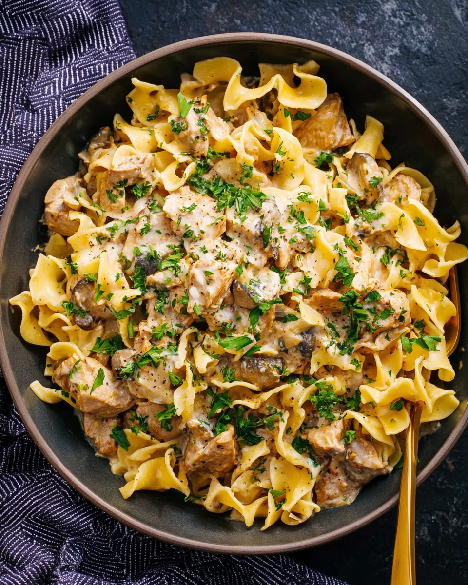 Delicious turkey stroganoff with egg noodles and fresh parsley