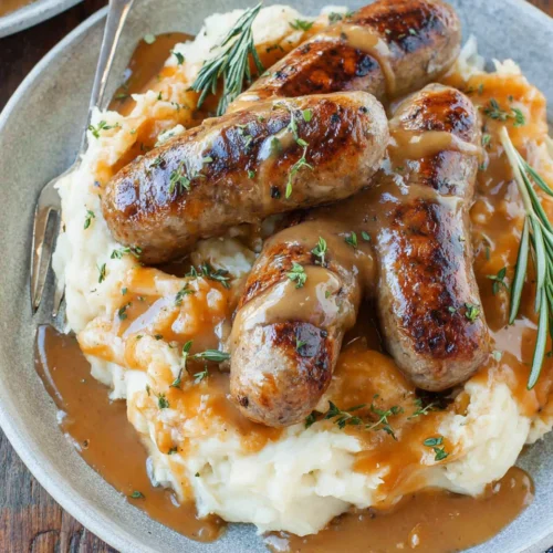 Bangers and Mash: A Cozy, Comforting Classic 1 Bangers and mash with sausages and gravy, a hearty comfort food.
