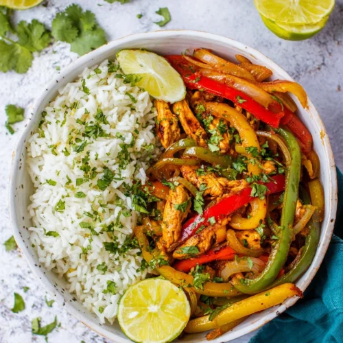 Easy chicken fajita bowls full of colorful veggies and rice.