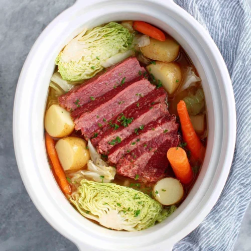 Corned beef and cabbage dish in a crockpot.