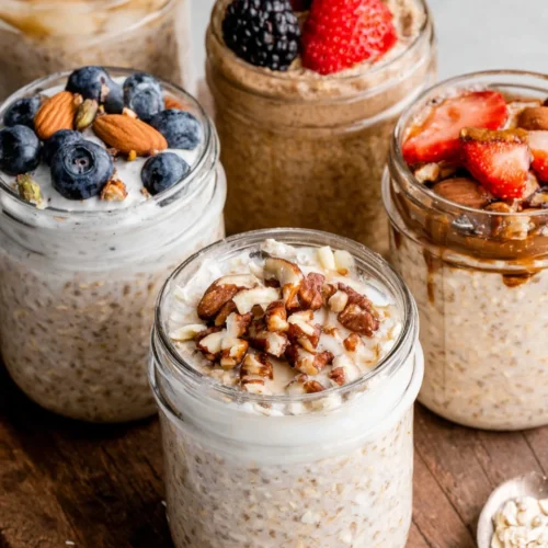 High-protein oats in jars, topped with fruits and yogurt.