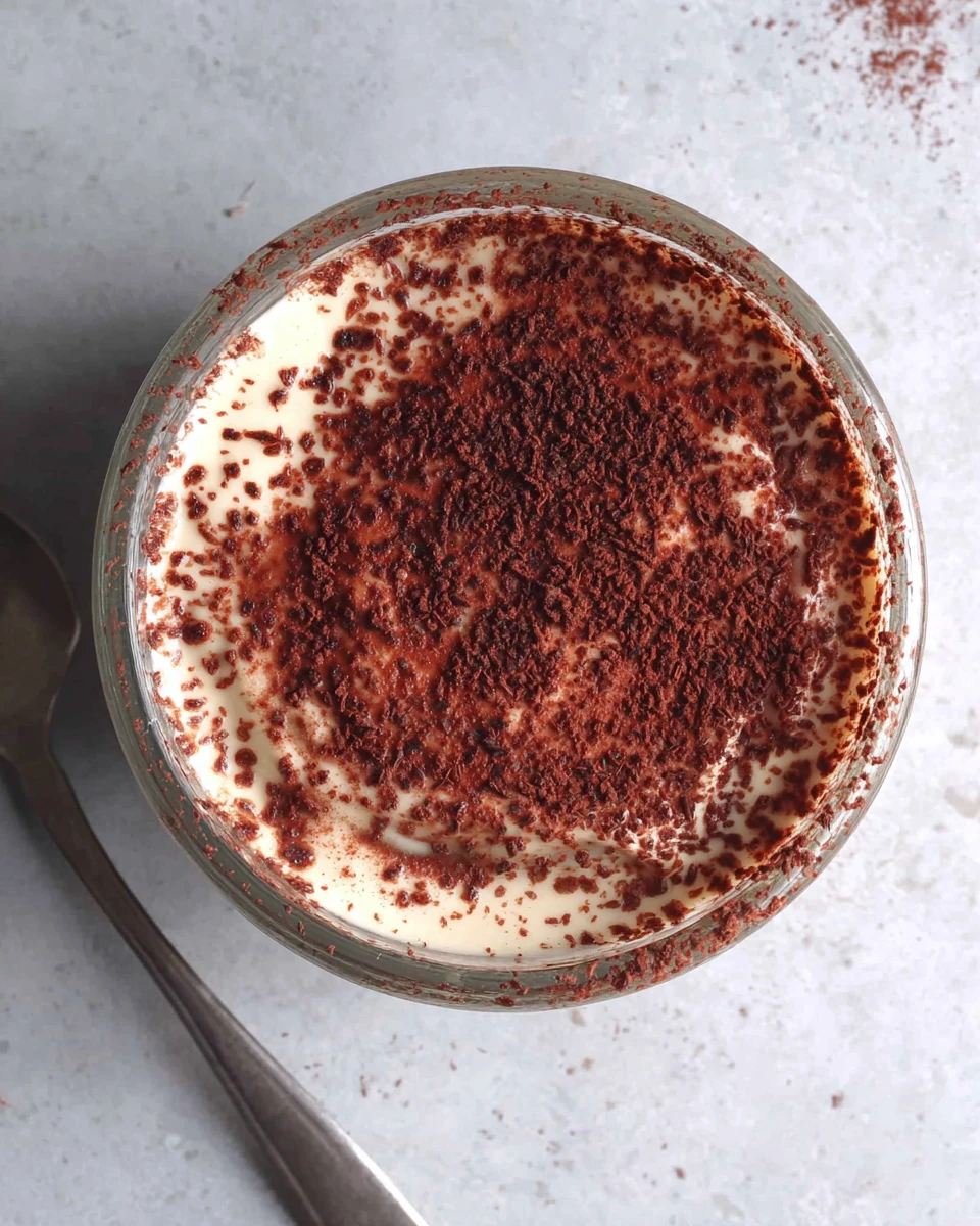 High protein tiramisu dessert served in a glass cup.