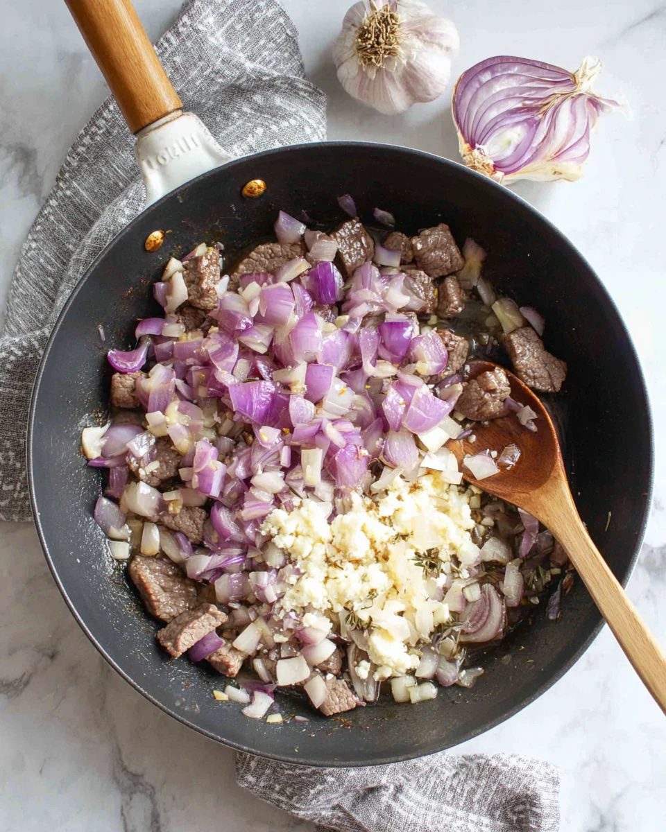 Sautéed shallots and garlic for Irish Steak and Ale Pie.