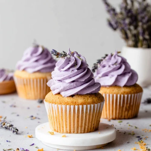 Lavender cupcakes topped with purple frosting, a delightful treat.