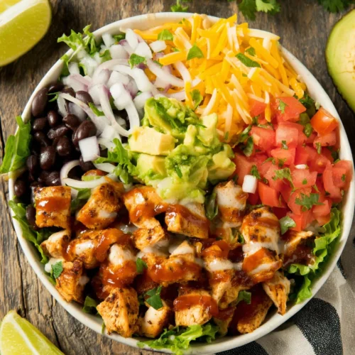 Low calorie chicken burrito bowl with rice, chicken, and toppings.