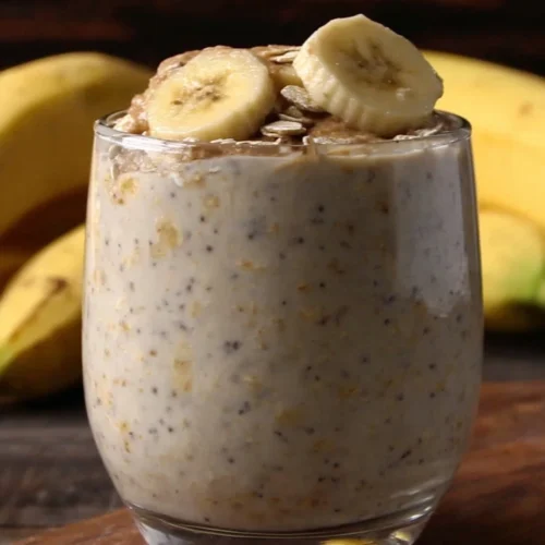 Creamy peanut butter banana oats in a glass, healthy breakfast treat.