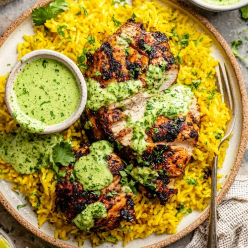 Delicious Peruvian chicken with yellow rice and green sauce