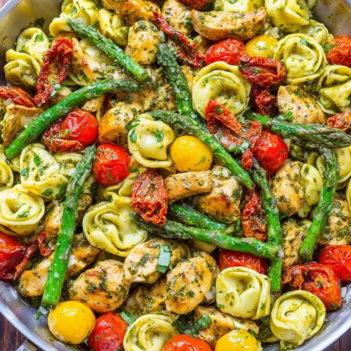 Delicious pesto chicken tortellini with fresh vegetables.