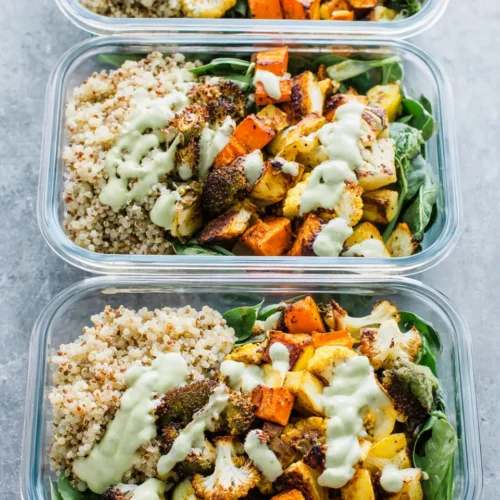 Quinoa meal prep bowls with roasted veggies and tahini dressing.