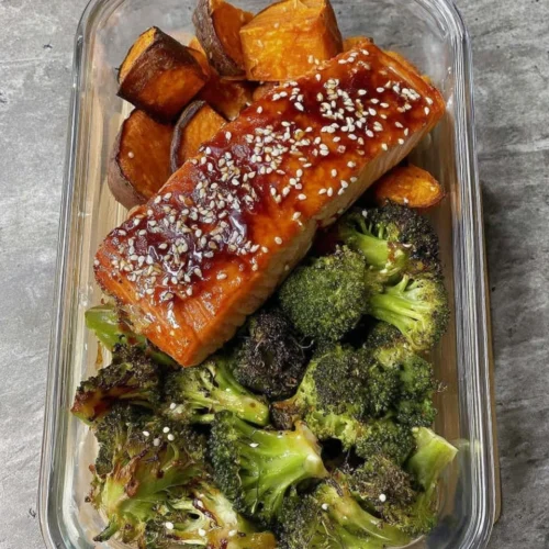 Healthy salmon meal prep with sweet potatoes and broccoli.