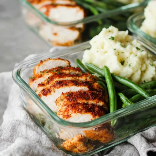 Spicy chicken meal prep with veggies and mashed cauliflower.