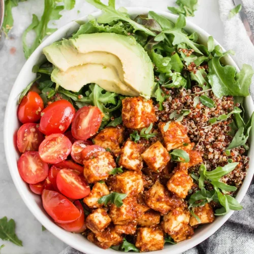 Delicious tofu quinoa bowls loaded with fresh ingredients.