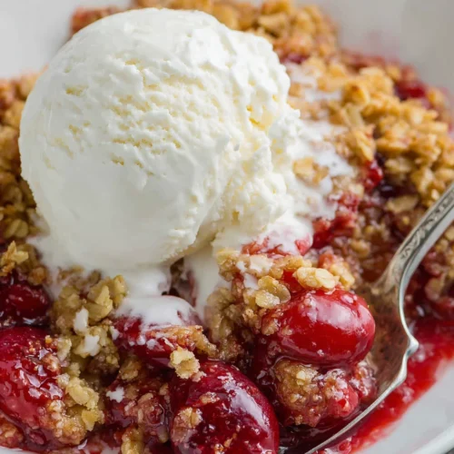 Delicious cherry oat crisp casserole dessert with ice cream.