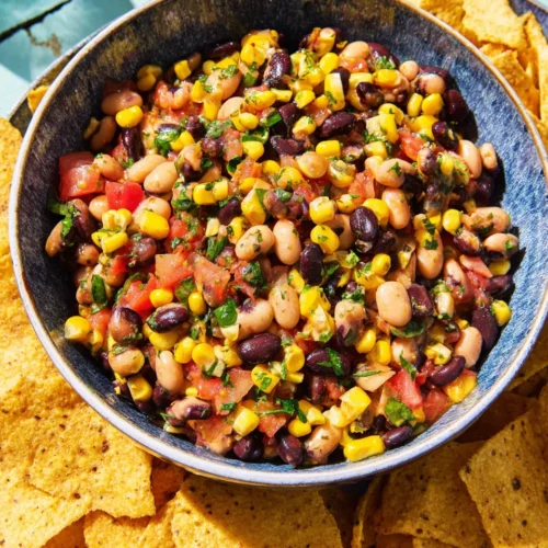 Cowboy Caviar: A Flavorful and Easy Delight 1 Cowboy caviar with beans and colorful veggies served with tortilla chips