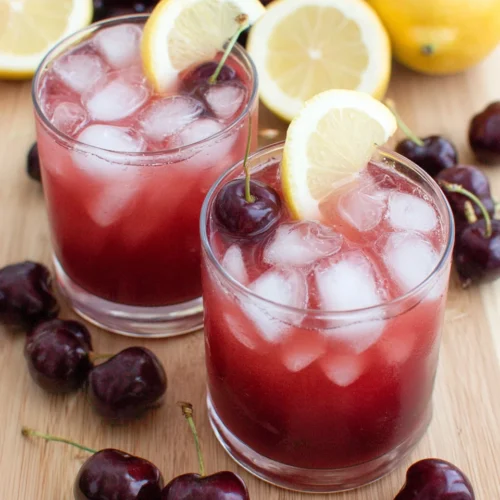 Refreshing homemade cherry lemonade with ice and lemon slices