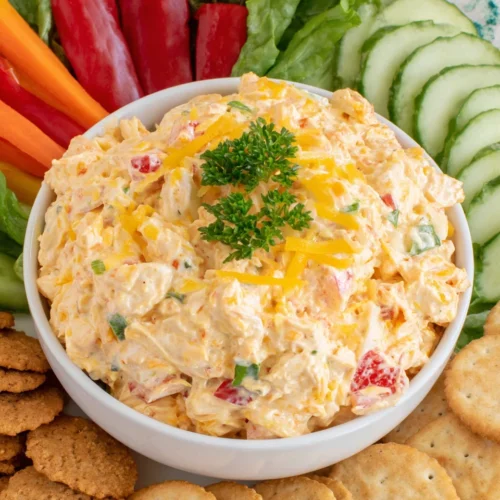 Pimento cheese chicken salad with vegetables and crackers.