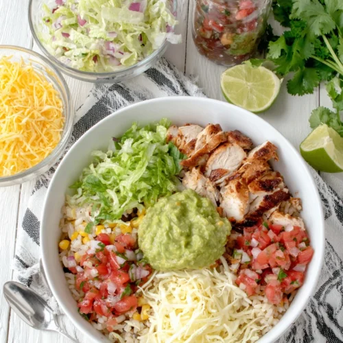 Delicious Chipotle chicken bowl with vibrant toppings and guacamole.