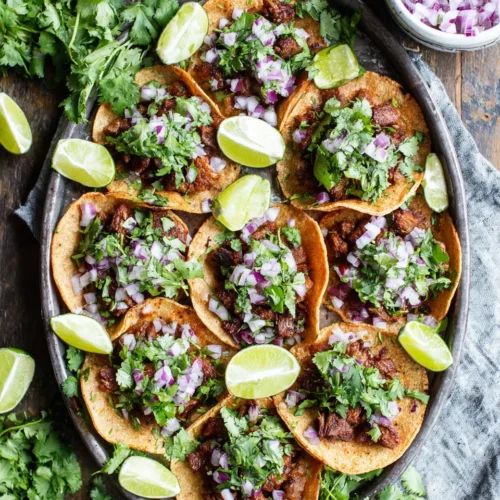 Easy Cinco de Mayo snacks: savory mini tacos topped with cilantro and onion.