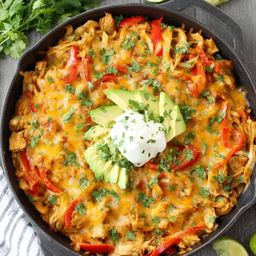 Easy chicken fajita casserole topped with cheese and avocado.