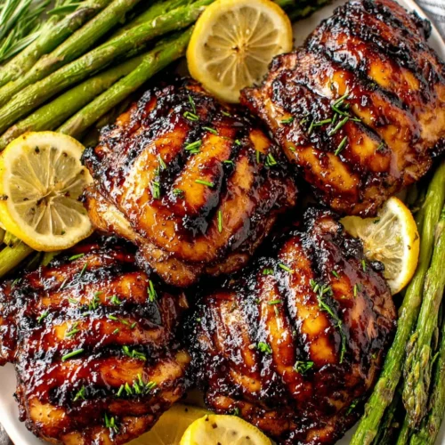 Grilled brown sugar glazed chicken thighs with asparagus and lemon slices