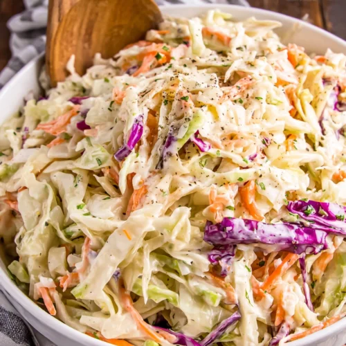 Creamy keto coleslaw with shredded cabbage and carrots in a white bowl