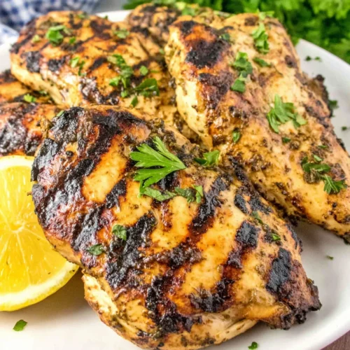 Mediterranean Grilled Chicken Breasts: A Zesty and Savory Delight 1 Mediterranean grilled chicken breasts with fresh herbs and lemon garnish