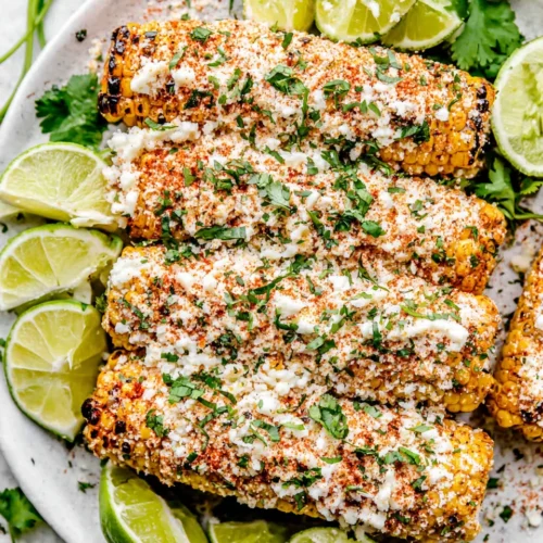 Delicious Mexican street corn (elote) topped with cheese and spices.