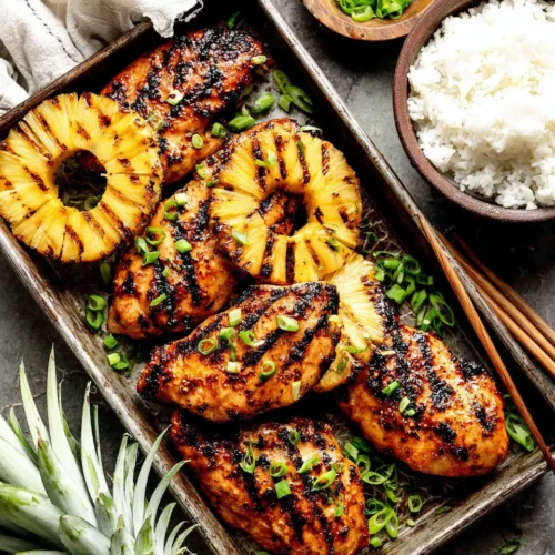 Pineapple Teriyaki Grilled Chicken: A Flavorful Delight 1 Grilled pineapple teriyaki chicken with char marks, pineapple slices, and green onions