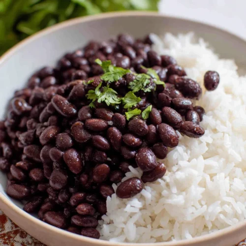 Seasoned vegan black beans served with rice, a healthy dish.