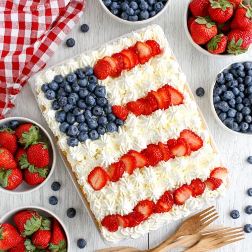 Angel food flag cake with strawberries, blueberries, and whipped cream