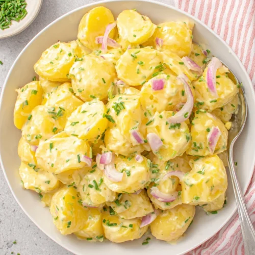 Austrian Potato Salad: A Flavorful Delight 1 Austrian potato salad with sliced potatoes, red onions, and chives in a creamy dressing