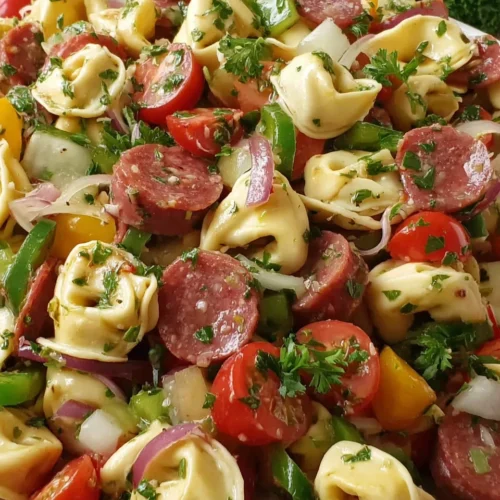 Costco tortellini pasta salad with tomatoes, salami, and fresh herbs
