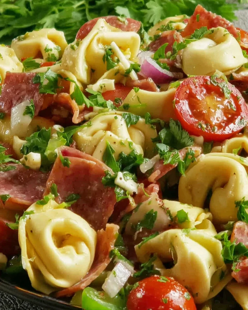 Costco tortellini pasta salad with tomatoes, salami, and fresh herbs