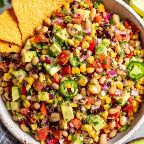 Cowboy Caviar: A Flavorful and Fun Dish 1 Colorful cowboy caviar salad with beans, corn, tomatoes, and tortilla chip