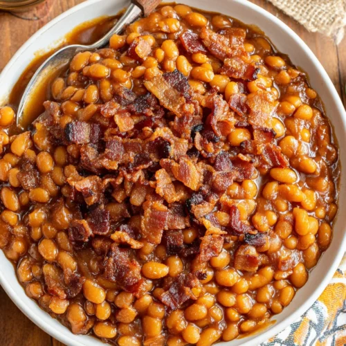 Crockpot Baked Beans: A Deliciously Easy Recipe 1 Crockpot baked beans with crispy bacon in a white bowl
