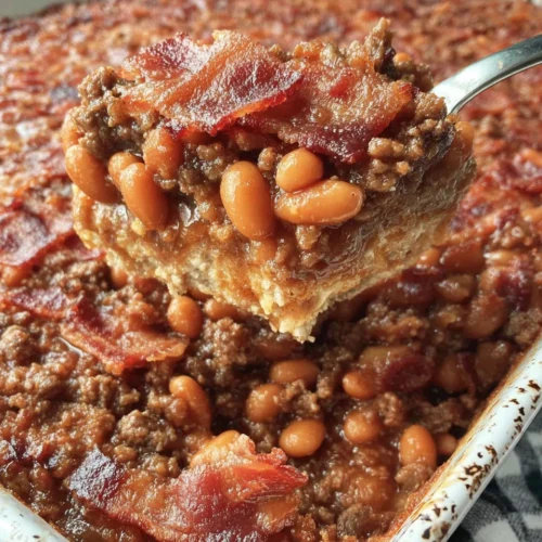 Easy baked beans with ground beef, bacon, and brown sugar in a casserole dish