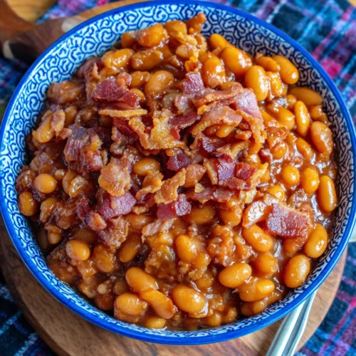Easy crock pot baked beans with bacon in a blue bowl
