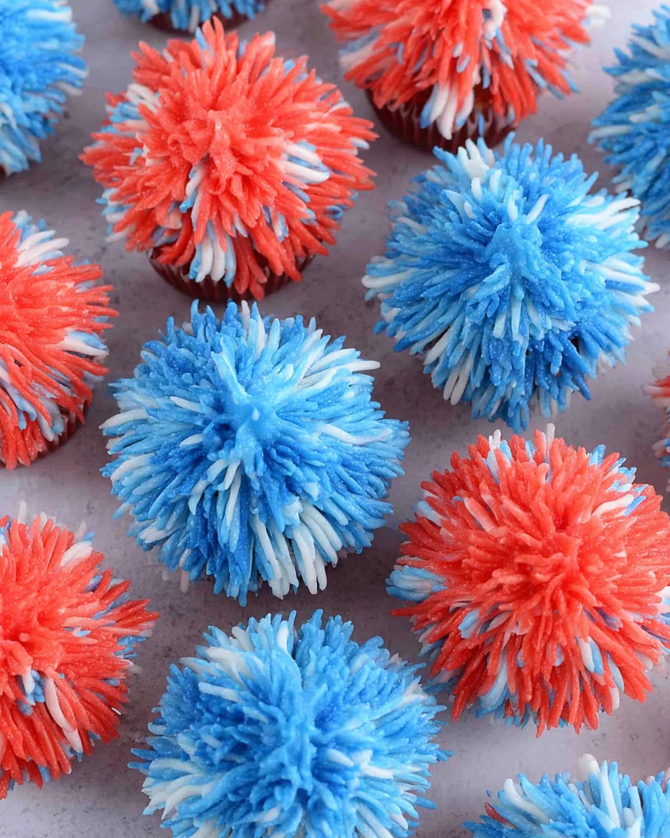 Easy fireworks cupcakes with red, white, and blue frosting in a fireworks design